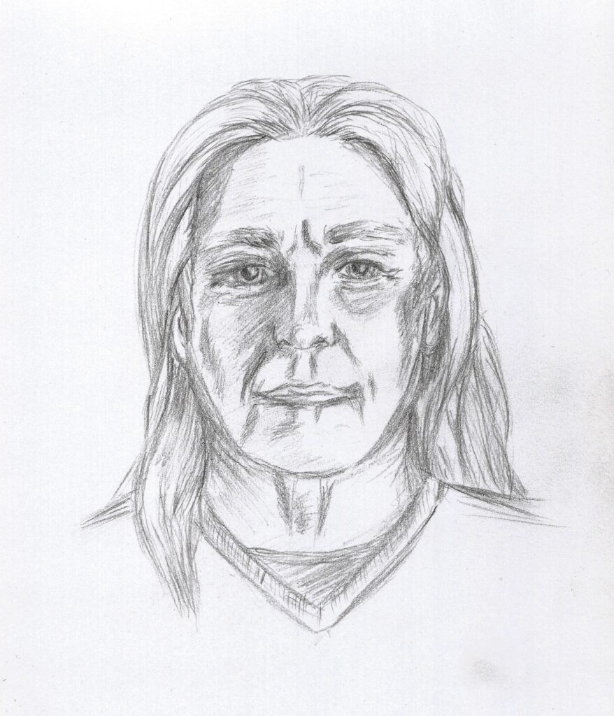 An older man with long hair wearing a vneck shirt in portrait